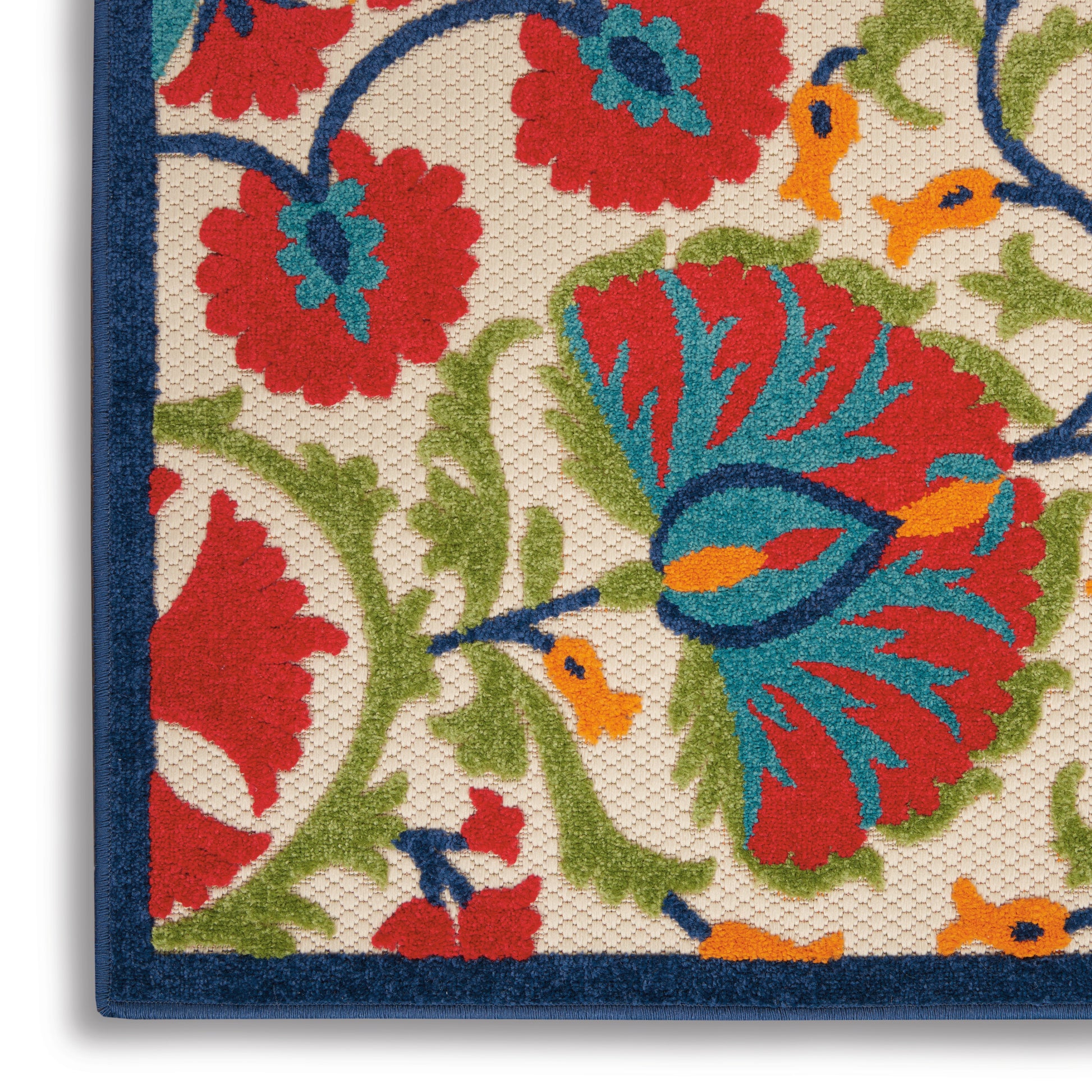 Close-up of a floral rug: red, blue & orange flowers on cream with green vines & a dark blue border.