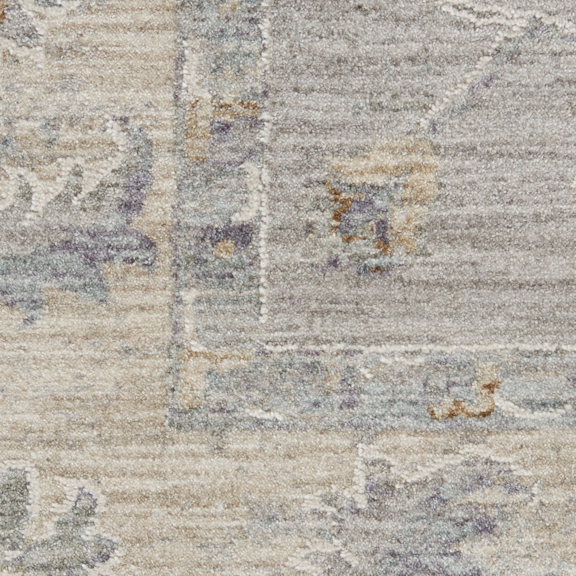 Distressed vintage-style area rug in beige, ivory and gray with soft lavender accents and subtle oriental floral pattern.