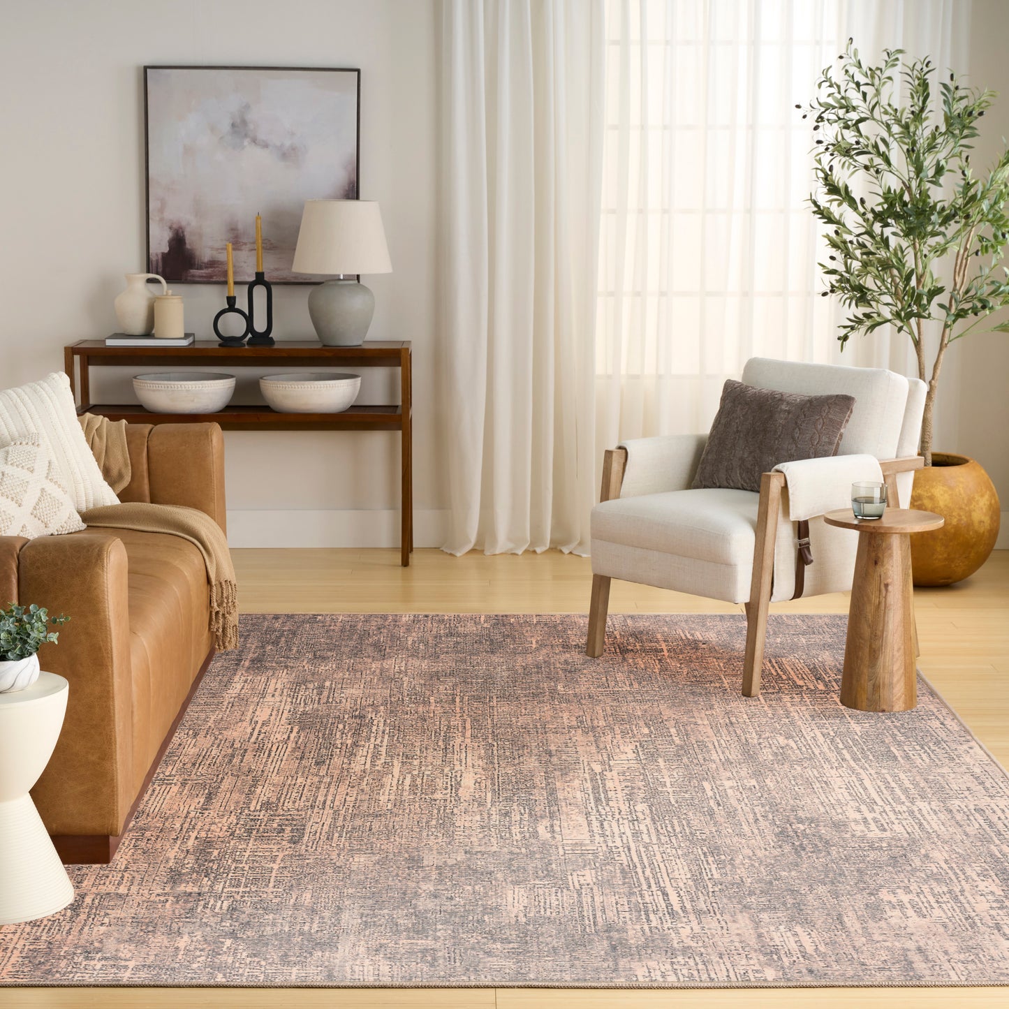 Muted lavender-gray area rug in a contemporary living room with a leather sofa, white armchair, and wood accents.