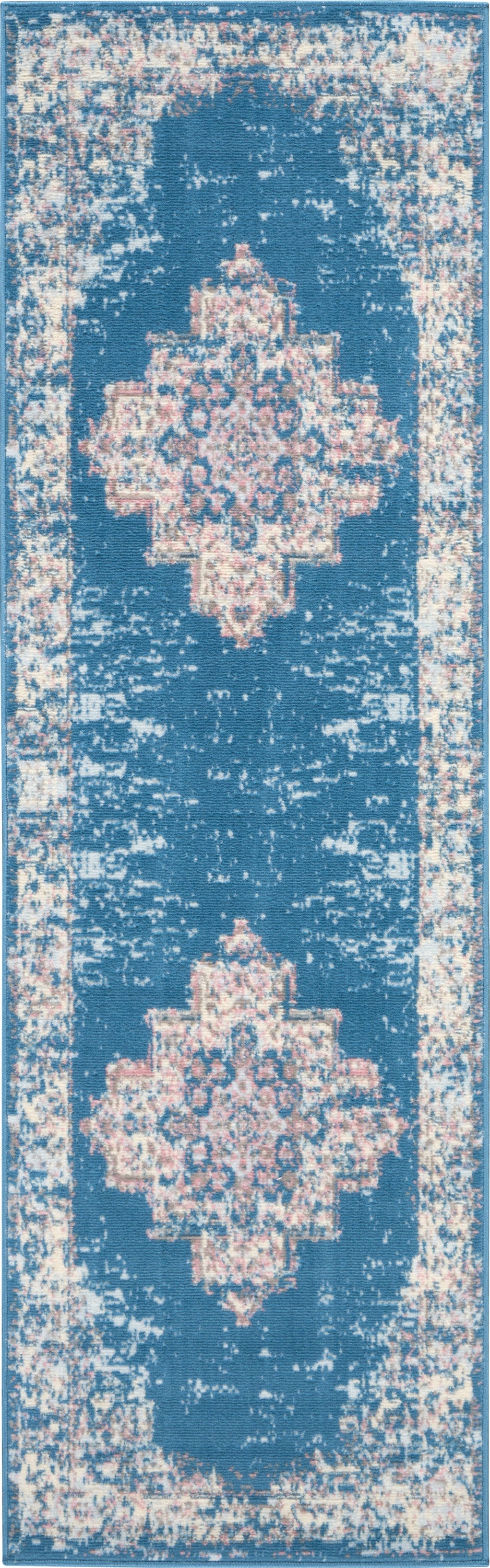 Blue distressed Persian-style runner rug with pale pink and cream floral medallions and bordered edges.