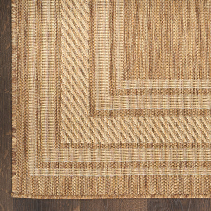 Natural jute rug with nested beige borders and a textured braided weave on dark wood floor.