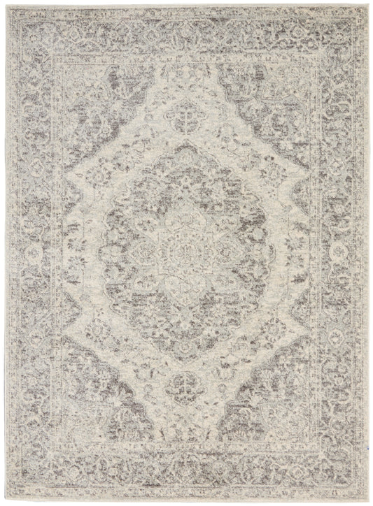 Ivory & gray distressed Persian-style rug with ornate central medallion & decorative border.