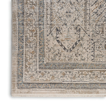 Beige and blue-toned oriental area rug close-up with intricate border patterns and tassel fringe.