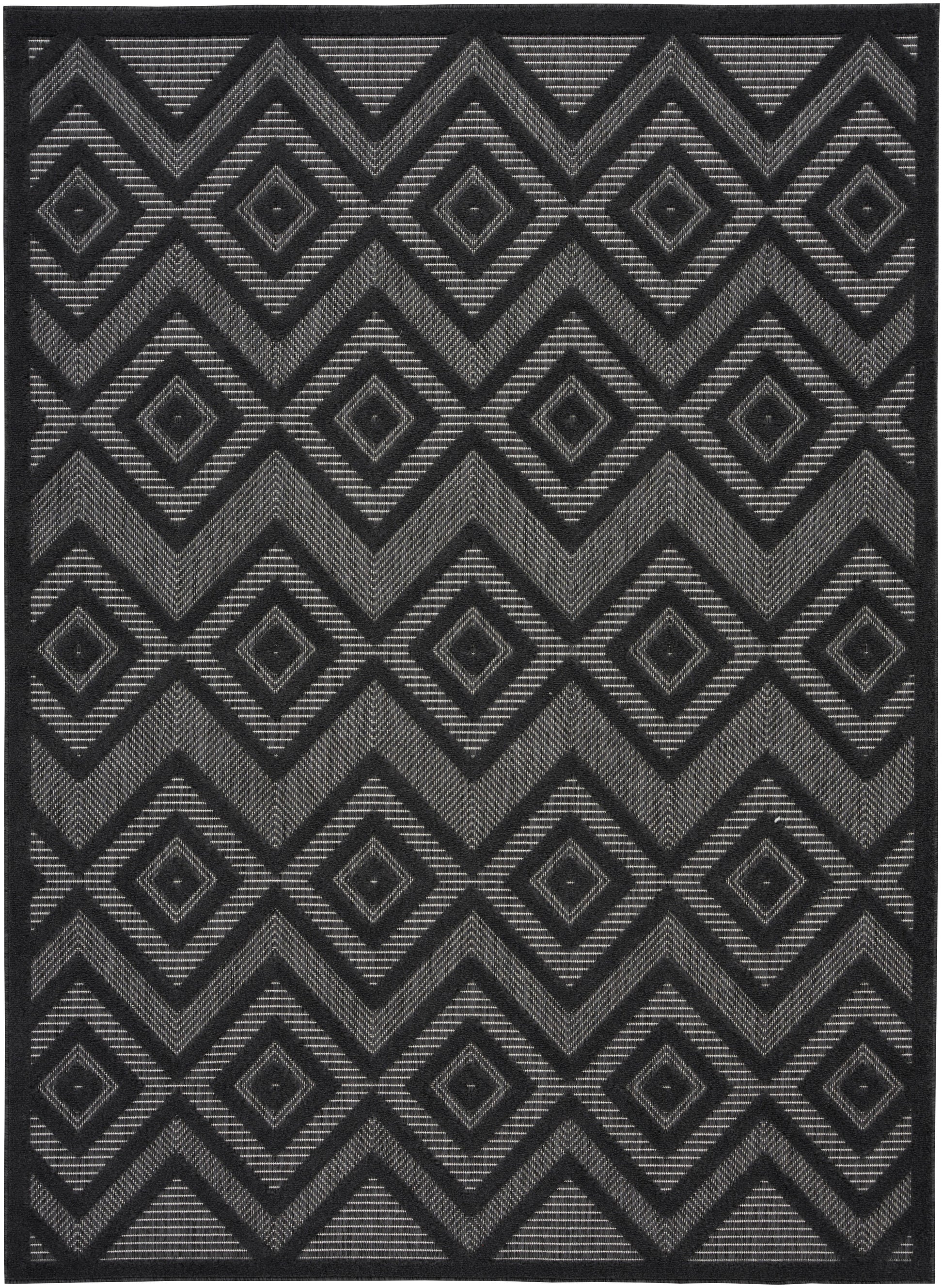 Black and gray geometric area rug with repeating diamonds and chevrons in a woven striped texture.