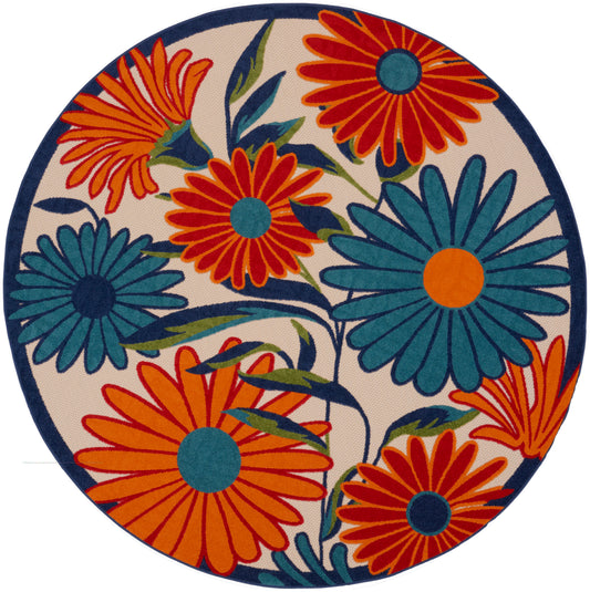 Round rug featuring bold orange and teal daisies on cream with a navy border.