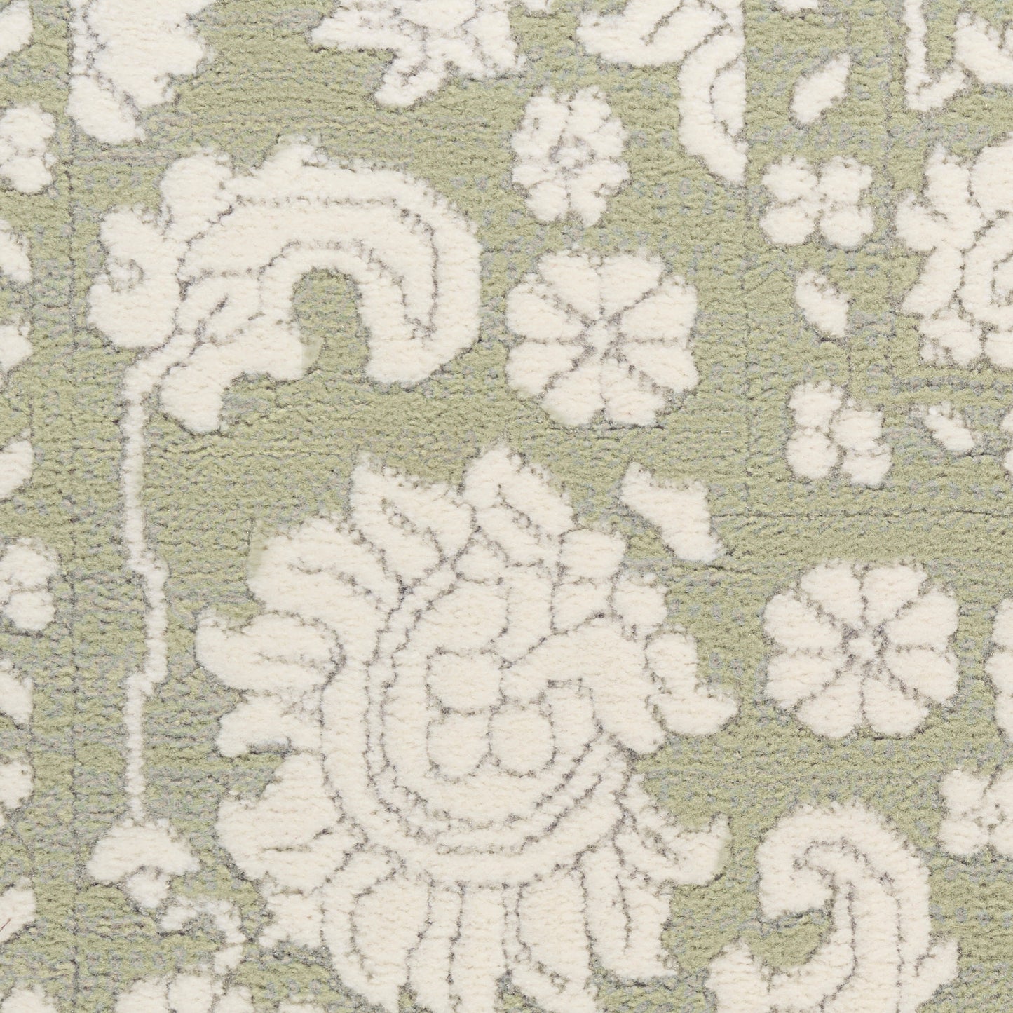 Olive-green rug with white damask floral pattern; decorative, textured textile.