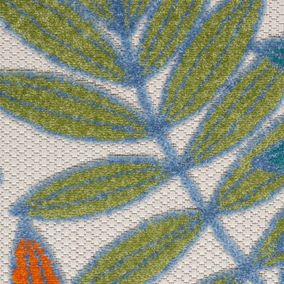 Close-up of embroidered fabric with olive-green leaf clusters and blue stems on a light beige background.