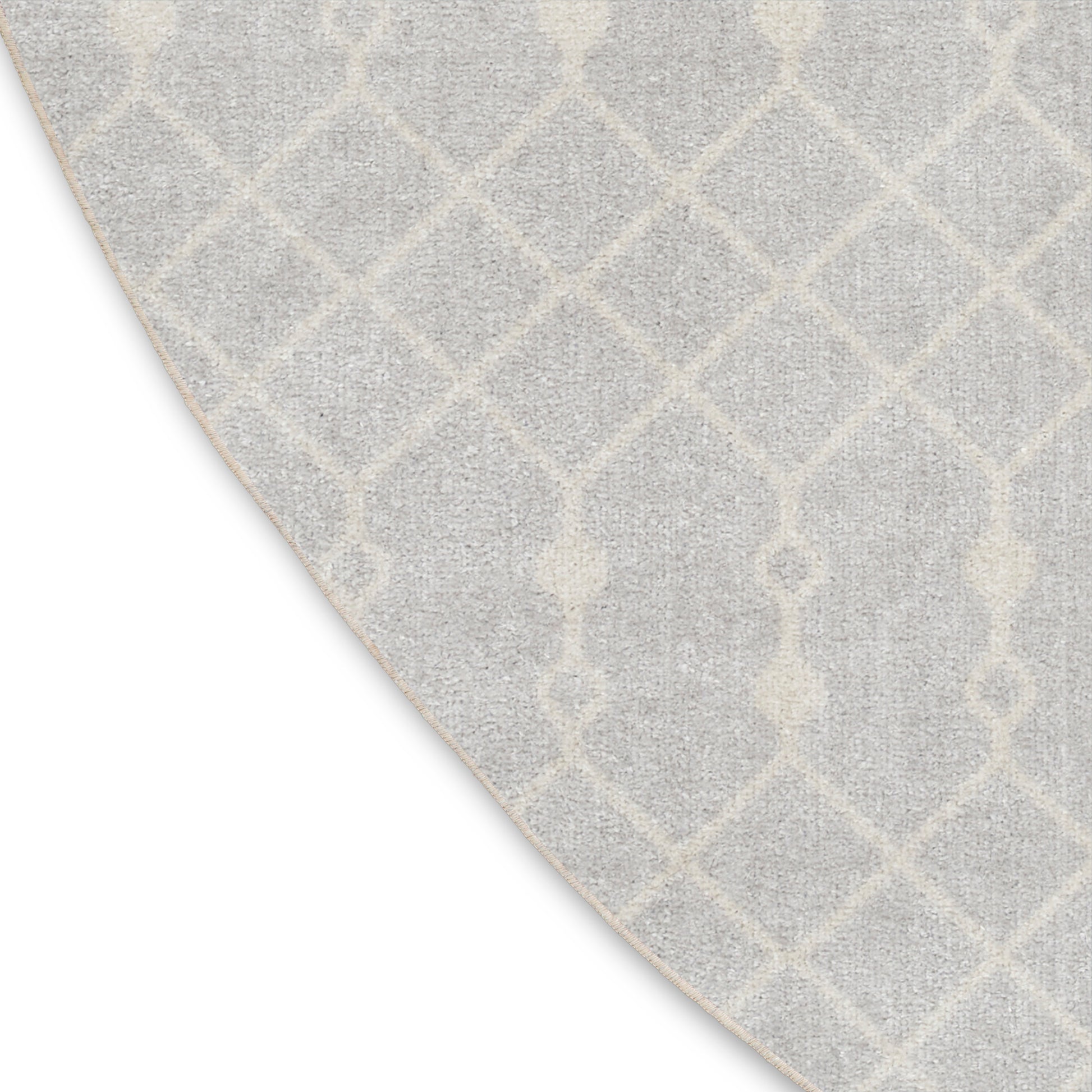 Round light gray area rug with white geometric lattice trellis pattern; soft, textured, contemporary home decor.
