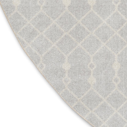 Round light gray area rug with white geometric lattice trellis pattern; soft, textured, contemporary home decor.