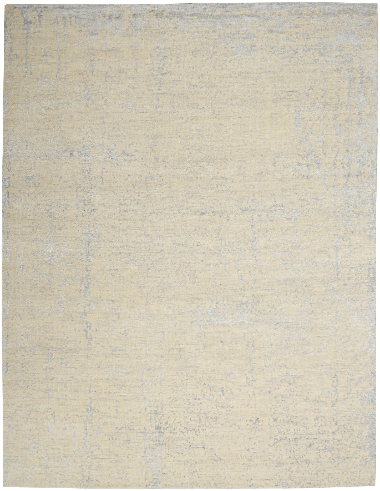 Beige distressed area rug with subtle blue-gray mottling; soft, low-pile, neutral floor covering.