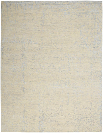 Beige distressed area rug with subtle blue-gray mottling; soft, low-pile, neutral floor covering.