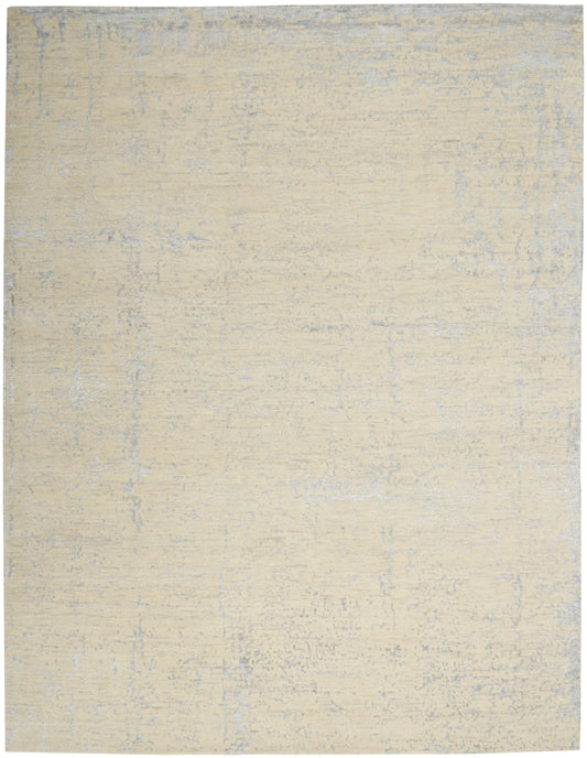 Beige distressed area rug with subtle blue-gray mottling; soft, low-pile, neutral floor covering.