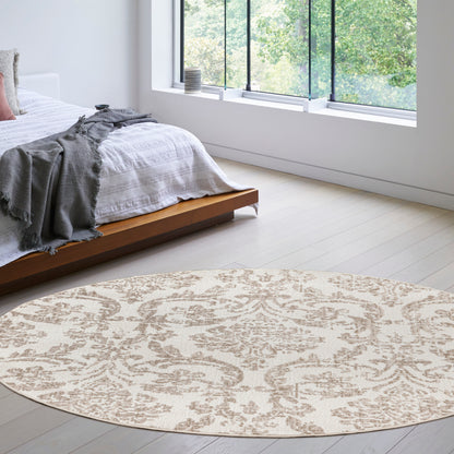 Round beige patterned area rug in a bright modern bedroom with white bedding and a low wood platform bed.