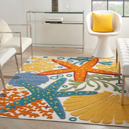 Coastal-style rug with yellow, orange, & blue starfish patterns in a modern living room; glass console table, white chair with yellow cushion.