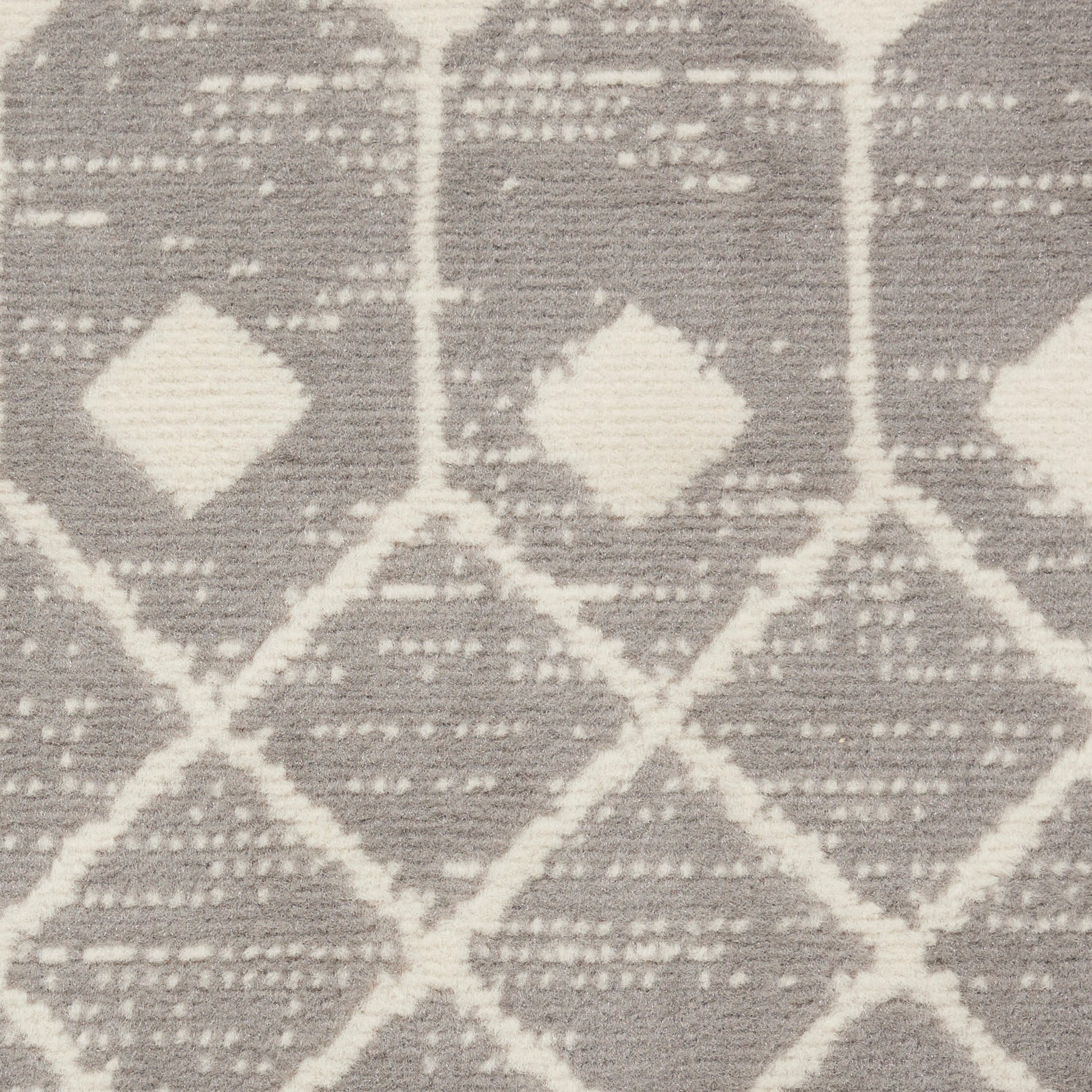 Gray and white geometric rug with diamond lattice pattern; woven textile, modern kilim style.