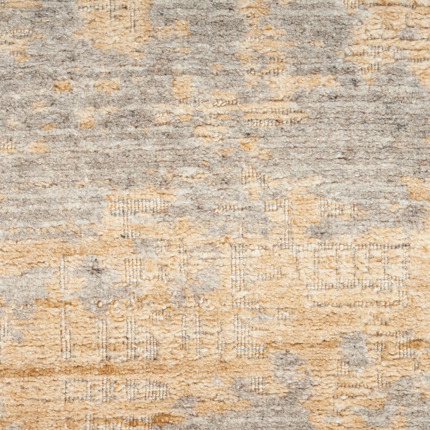 Abstract grey and tan area rug with distressed motifs and plush texture, modern boho decor.