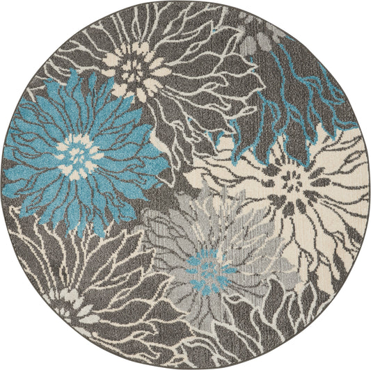 Round rug featuring large turquoise blue and cream flowers on a gray background with textured weave.