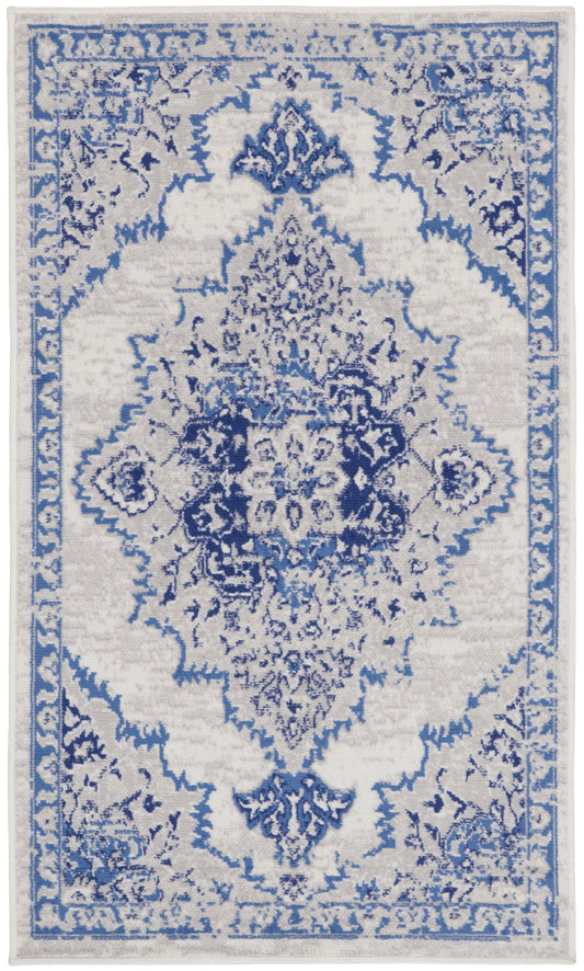 Blue and ivory oriental rug with ornate central medallion and floral border; Persian-inspired vintage style.