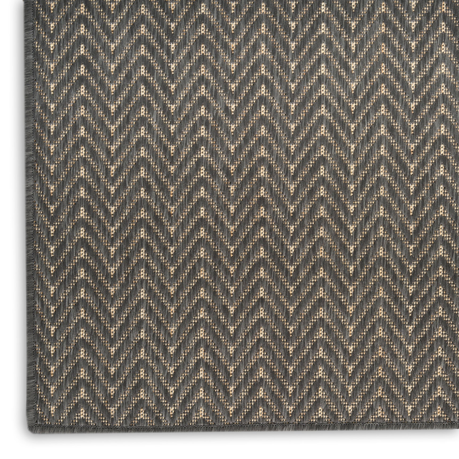 Charcoal gray & beige herringbone rug with chevron pattern; woven texture with bound edges.