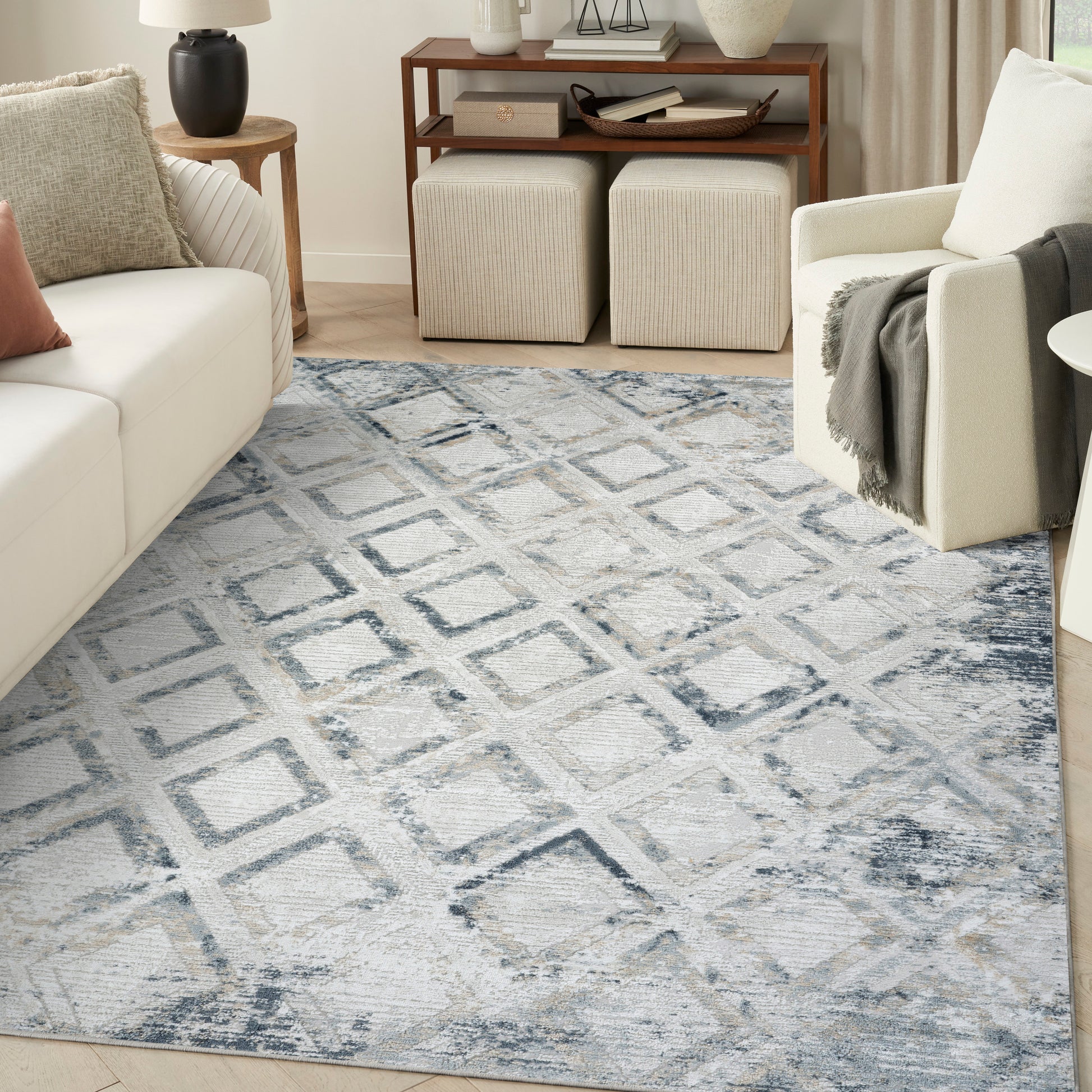 Soft blue-gray geometric area rug with diamond pattern in a modern living room.