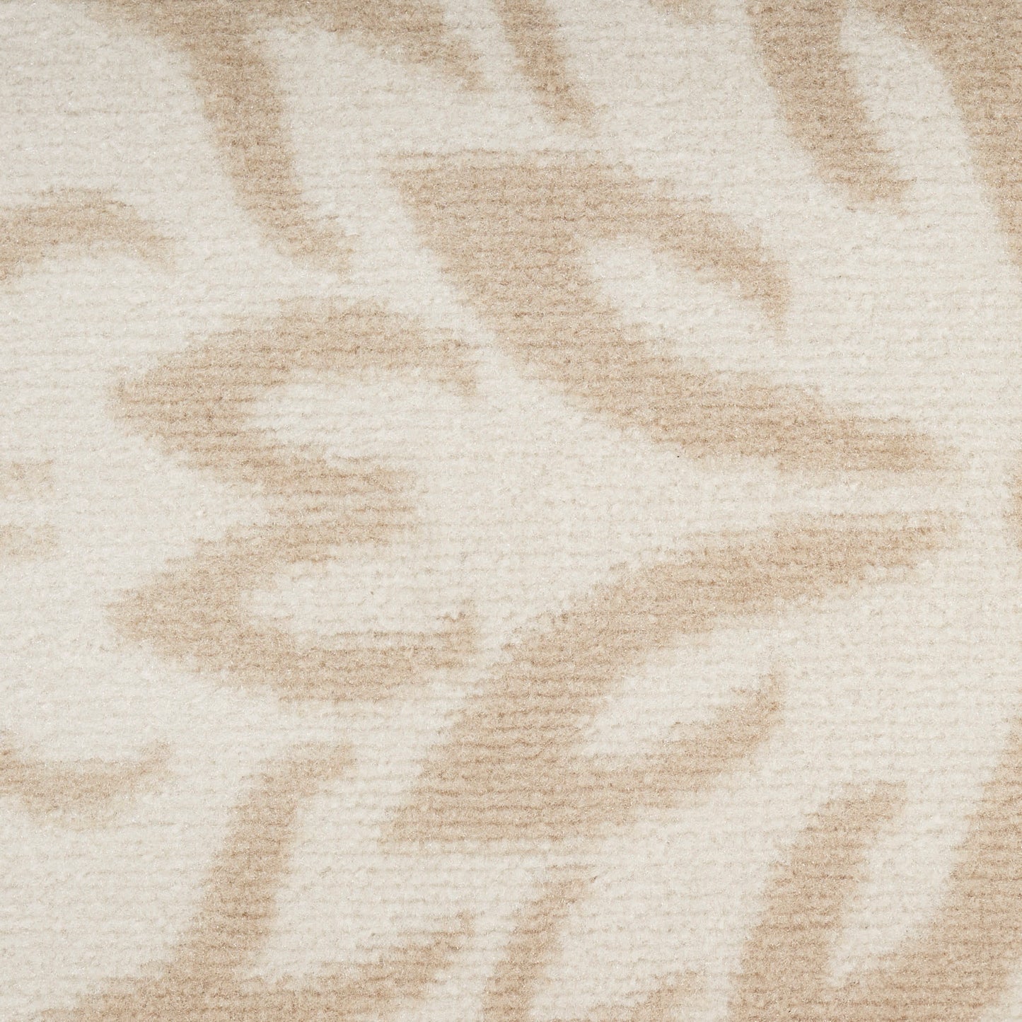 Cream-beige plush rug with a subtle taupe abstract leaf pattern; cozy living-room textile.