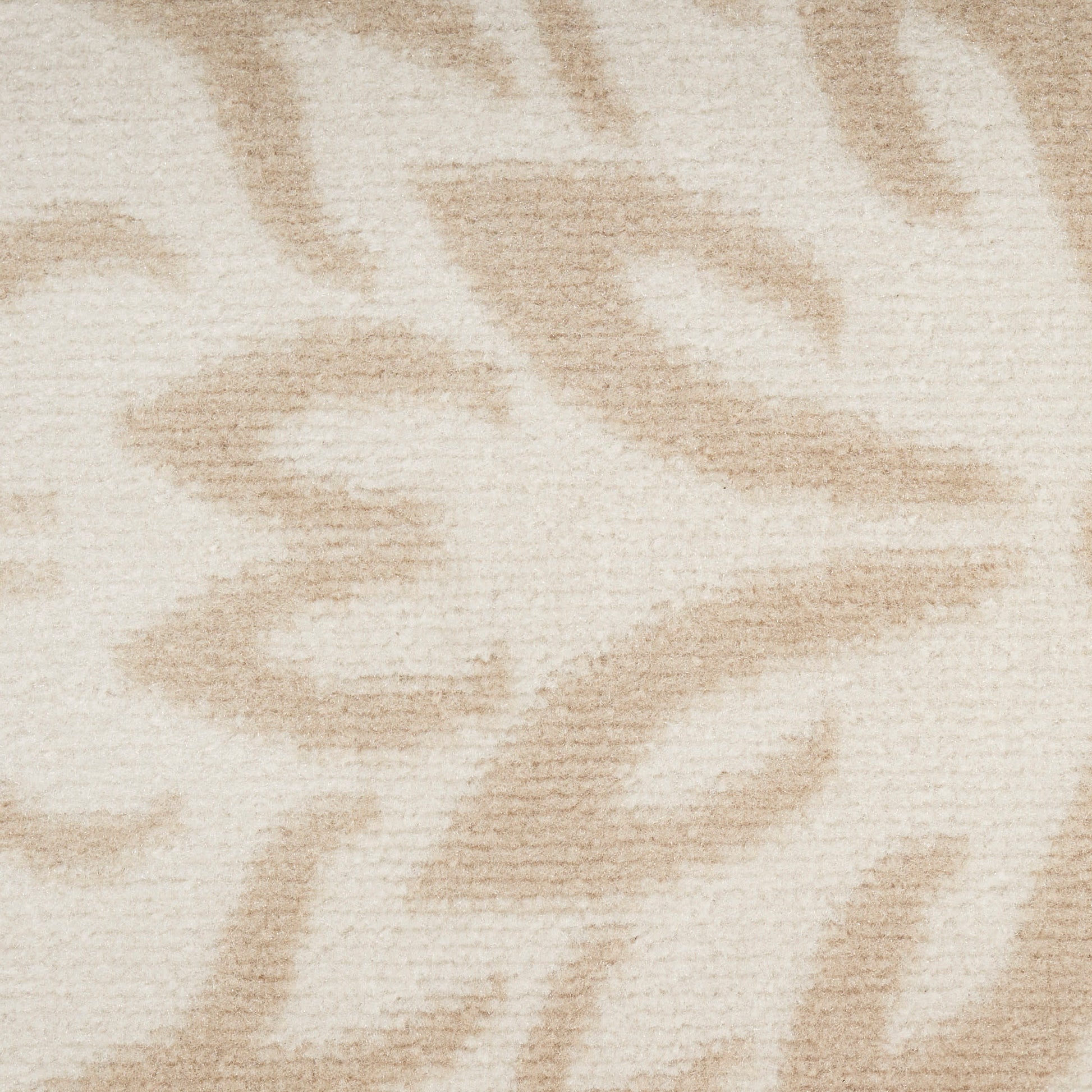 Cream-beige plush rug with a subtle taupe abstract leaf pattern; cozy living-room textile.
