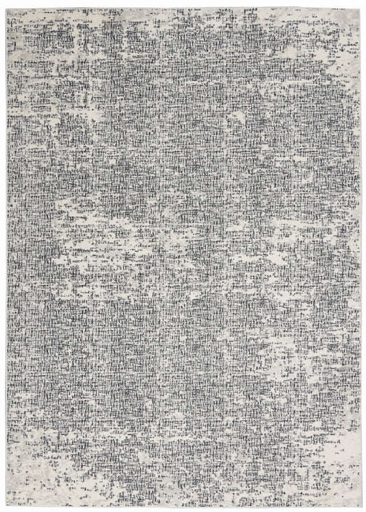 Rectangular rug with a distressed gray and charcoal speckle pattern.