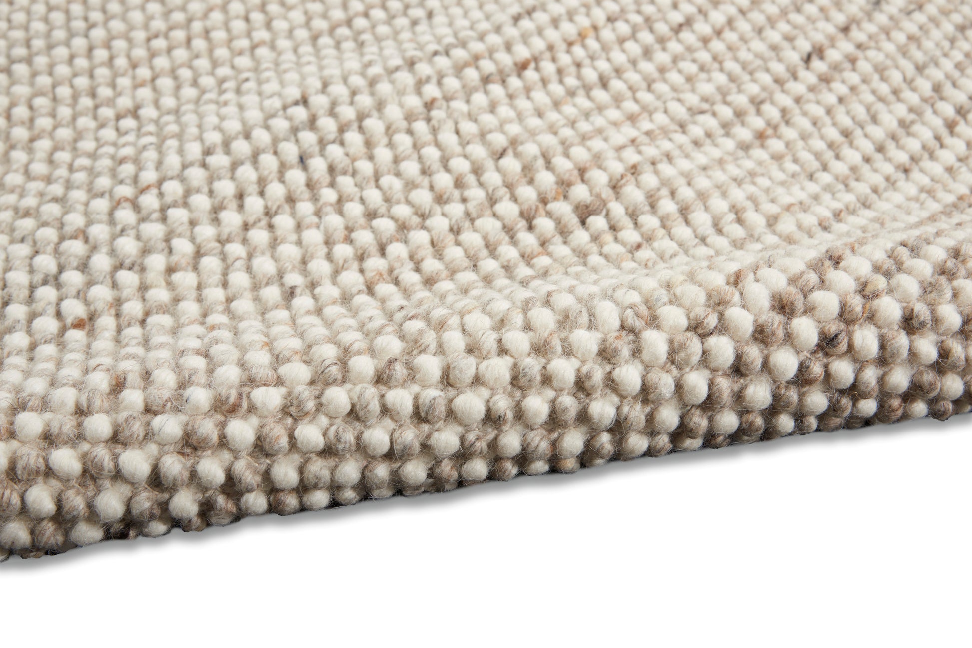 Beige loop-pile rug close-up with cream-taupe round tufts and soft woven texture