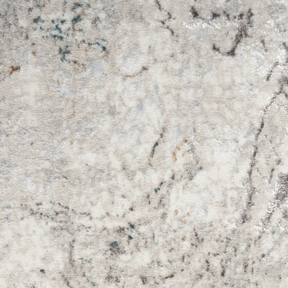 Cream-beige abstract area rug with marbled gray & teal accents, textured plush pile, modern cozy decor.