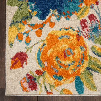 Vibrant floral area rug closeup with a large orange-yellow blossom, teal accents, and colorful petals on beige, tufted pile.