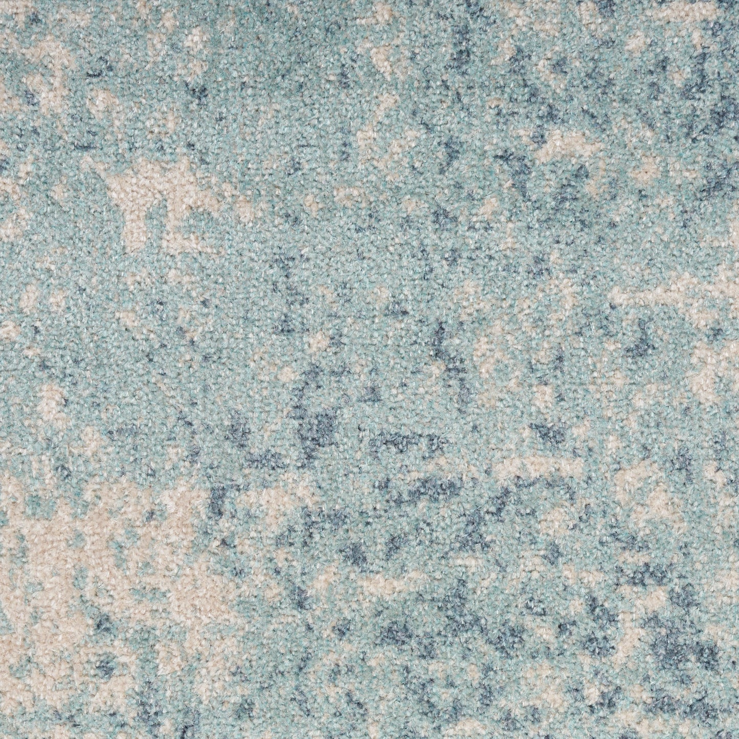 Blue-toned area rug with ivory distressed pattern and soft textured pile.