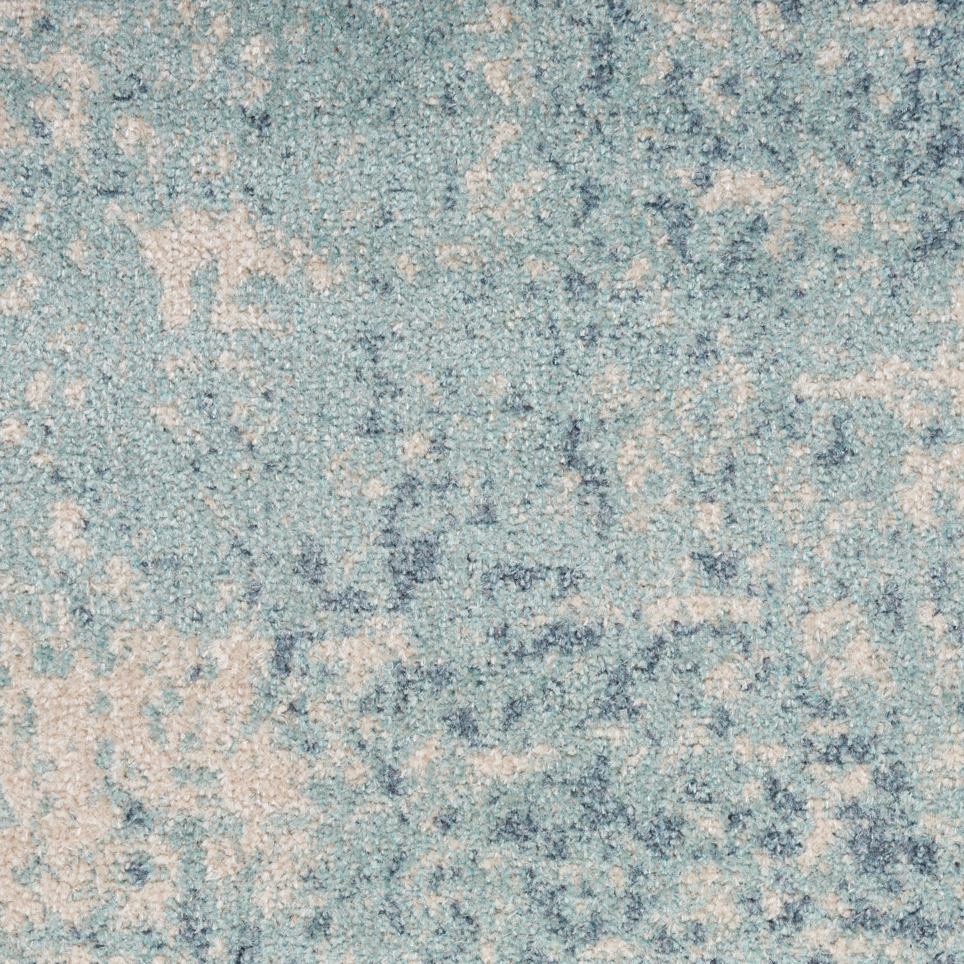 Blue-toned area rug with ivory distressed pattern and soft textured pile.