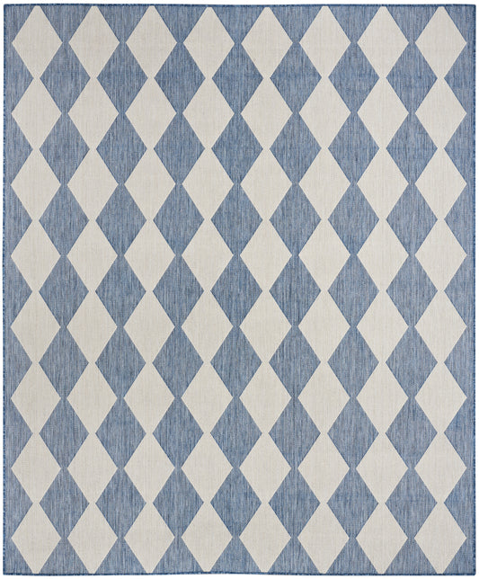 Rectangular woven rug with cream diamond pattern on blue textured field; modern geometric floor decor.