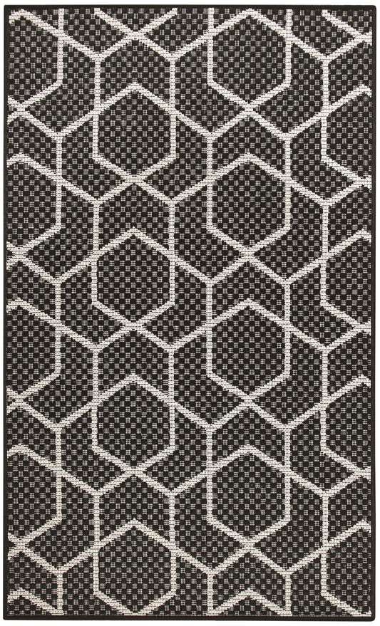 Black and white geometric rug with interconnected hexagons and dotted interiors; modern flat-weave style.