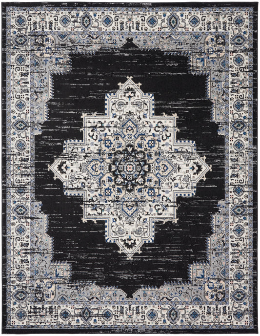 Rectangular oriental rug with distressed black field and ivory-blue central medallion surrounded by blue-gray border.