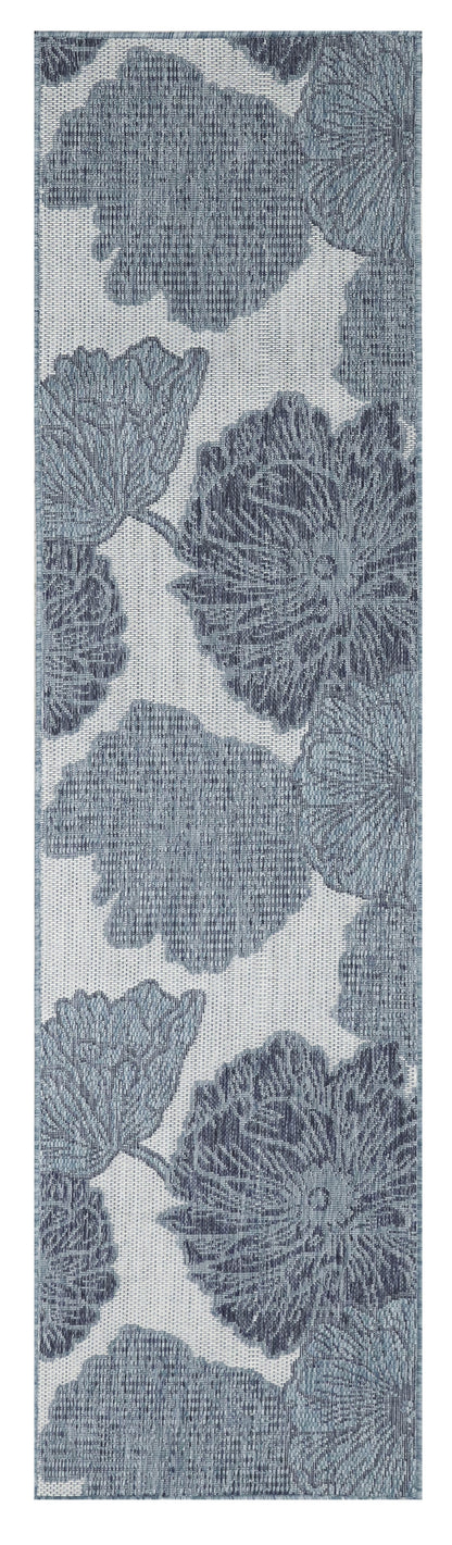Narrow vertical textile/wallcovering with large blue floral motifs resembling chrysanthemums on light background.