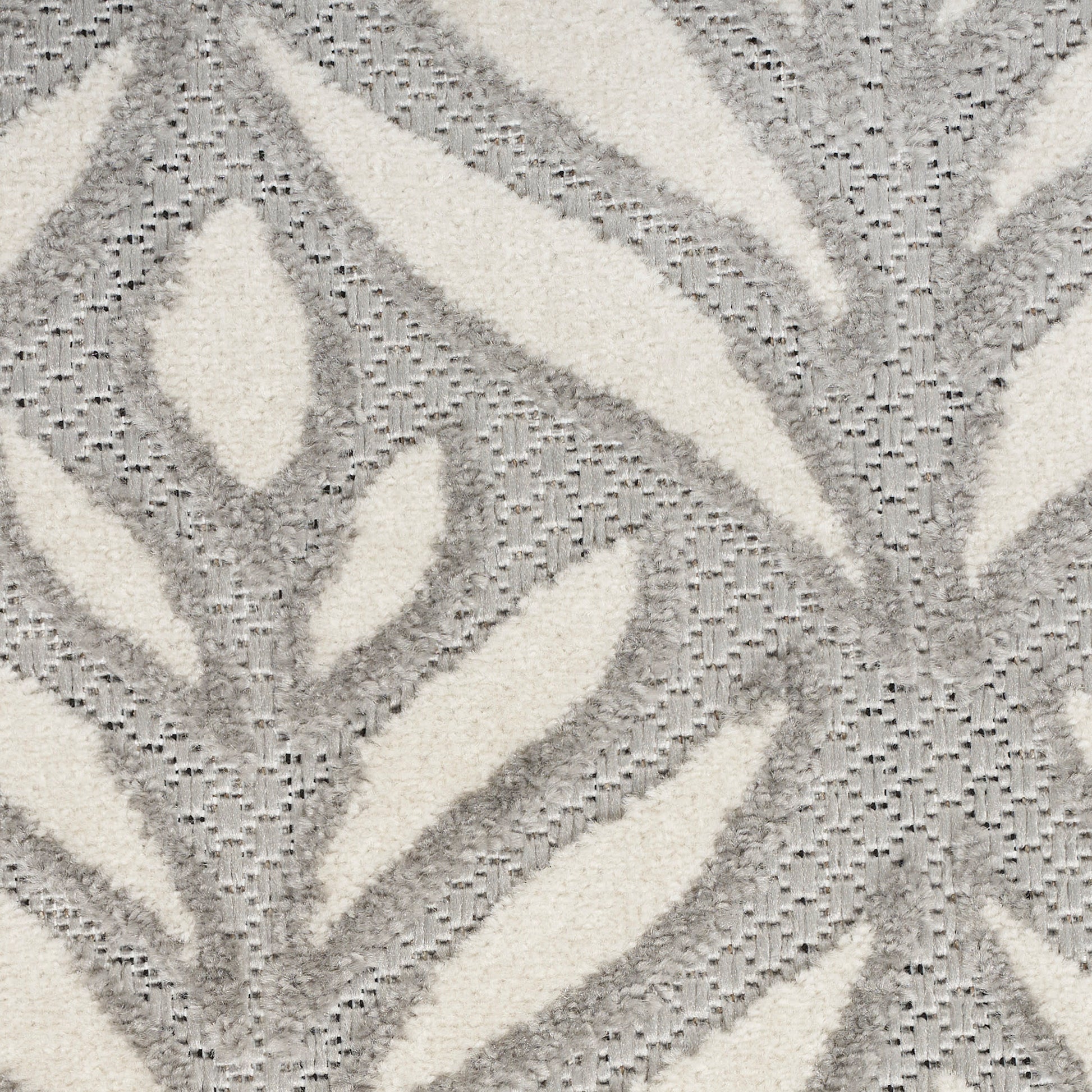 Ivory and gray plush rug featuring an abstract leaf pattern with raised texture.
