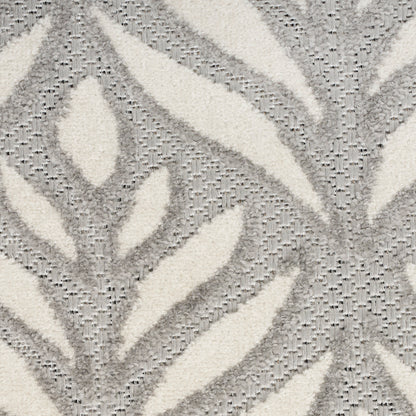 Ivory and gray plush rug featuring an abstract leaf pattern with raised texture.