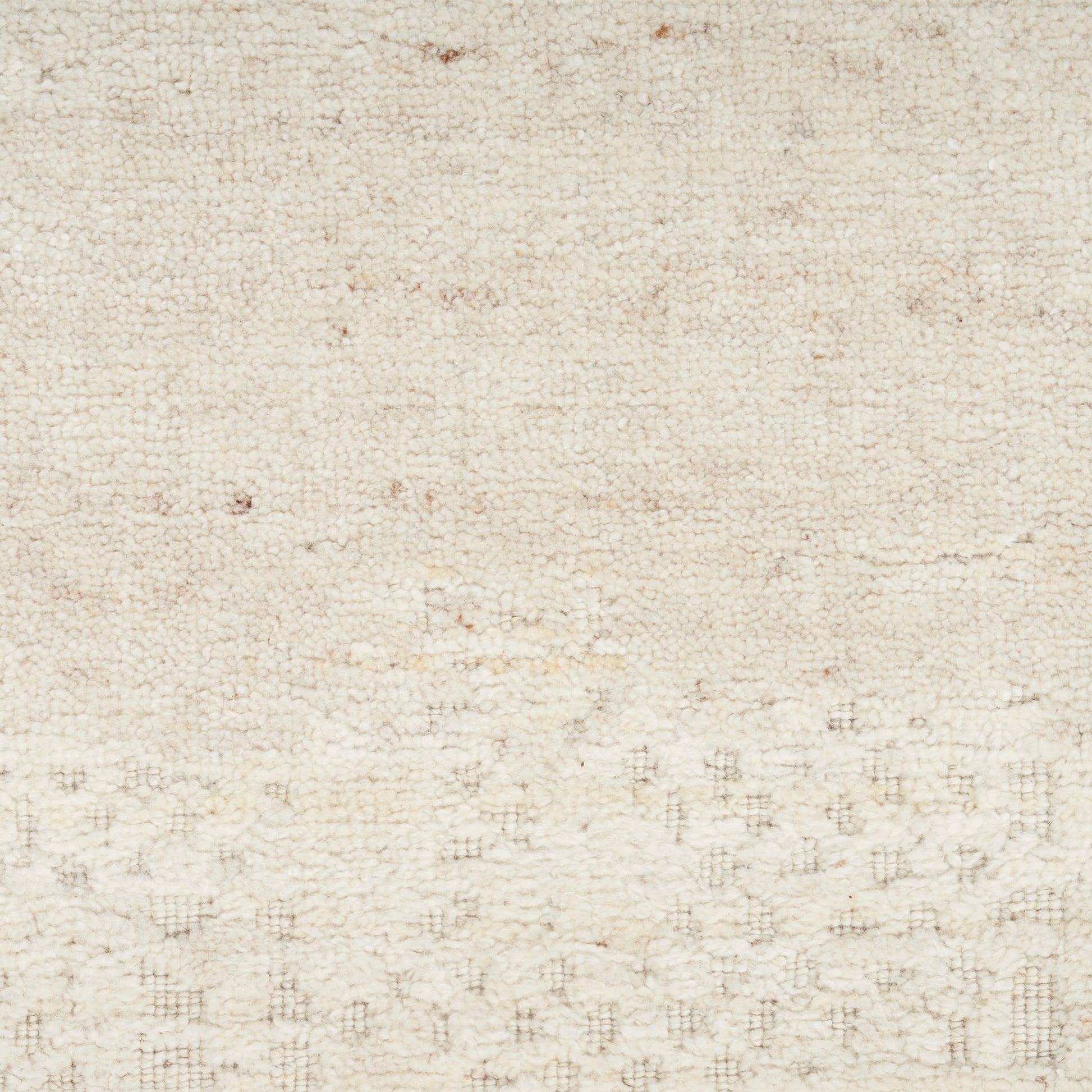 Cream-beige textured rug with soft woven fibers and subtle pattern.