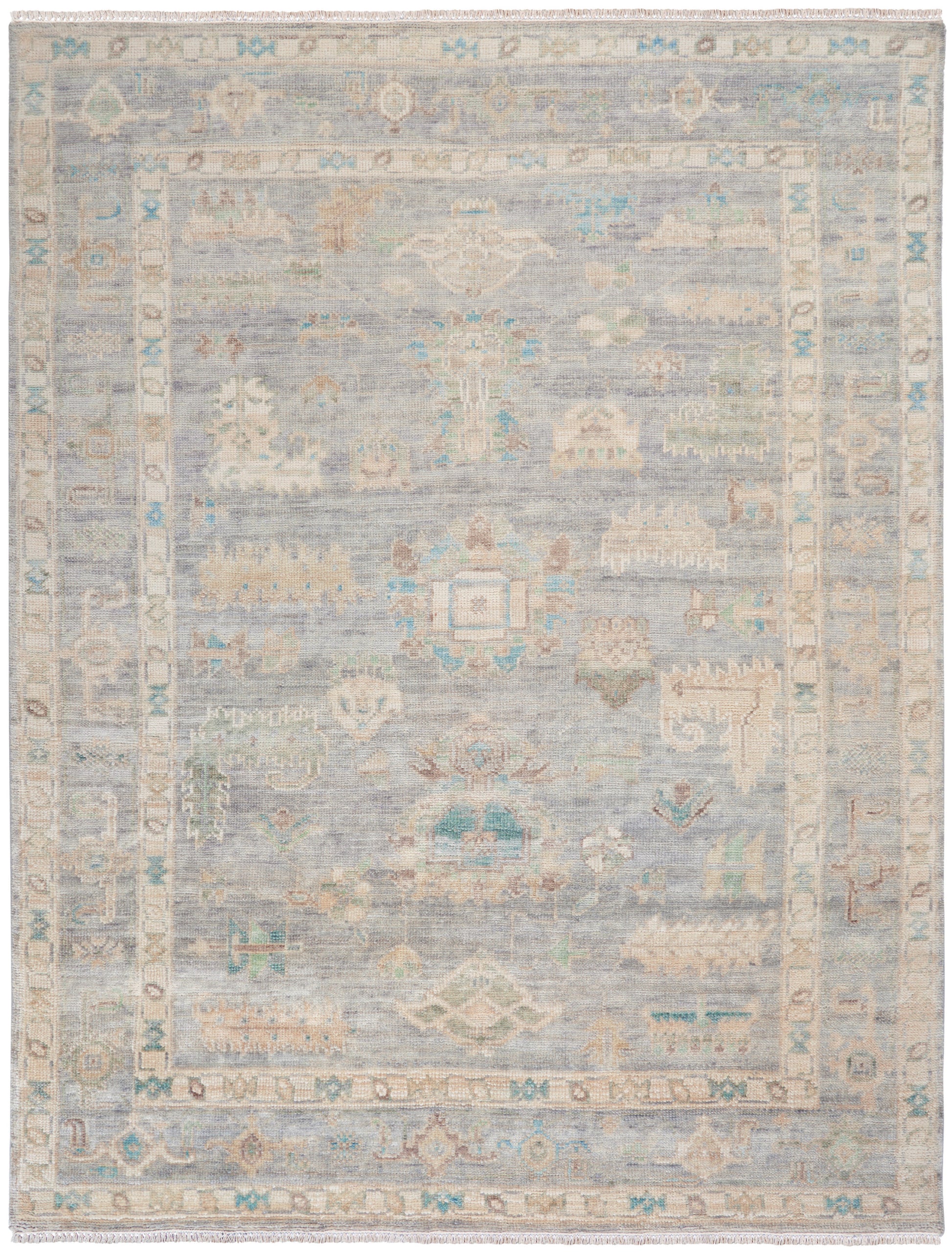 Pastel blue & ivory distressed oriental rug with geometric motifs, fringe edges, soft vintage look for living room decor.