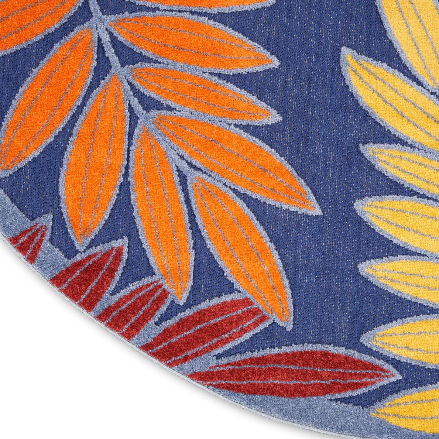 Round rug featuring blue backdrop with bold orange, yellow, and red leaf motifs.