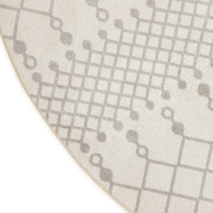 Cream rug with gray grid pattern and circular dot accents; soft textured pile, curved edge.