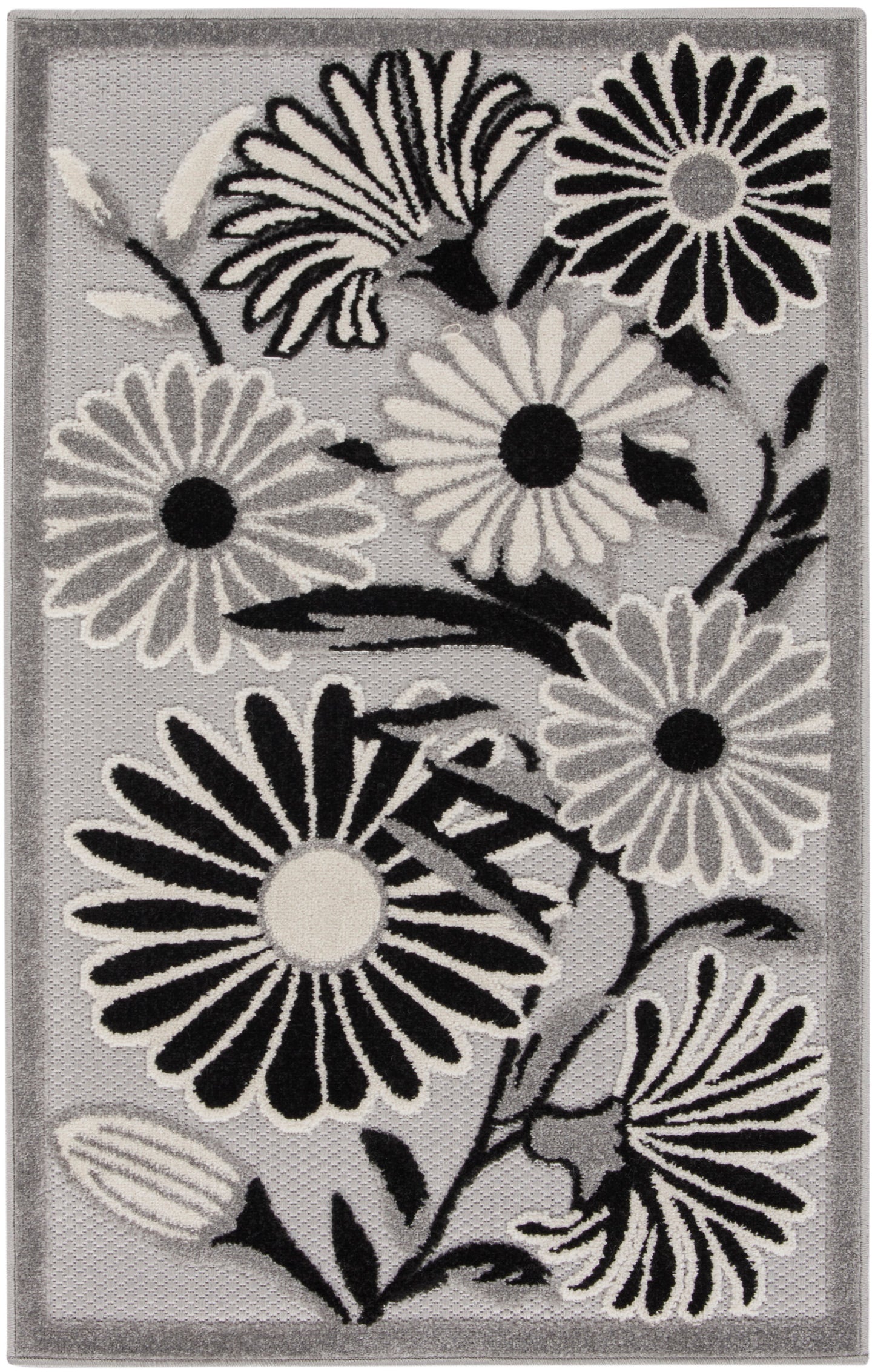 Rectangular grey area rug with bold black-and-white daisy flowers and a subtle border.