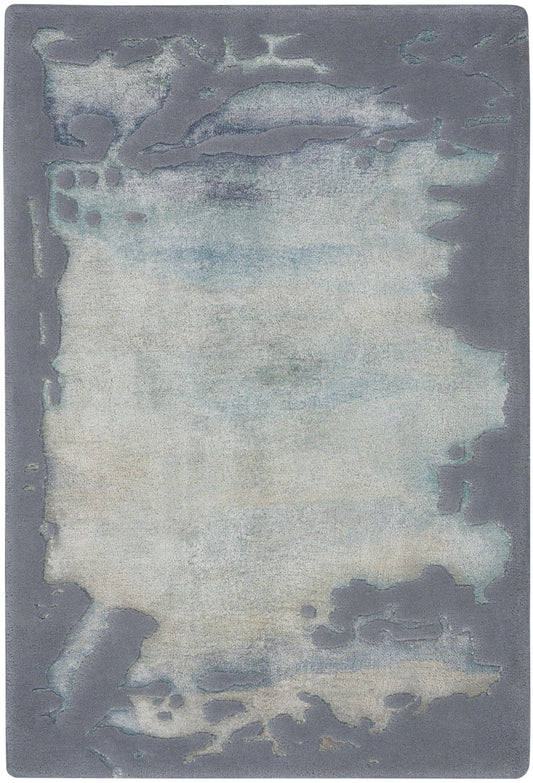 Abstract wash area rug with pale ivory center fading to blue, framed by blue-gray border; soft plush texture.