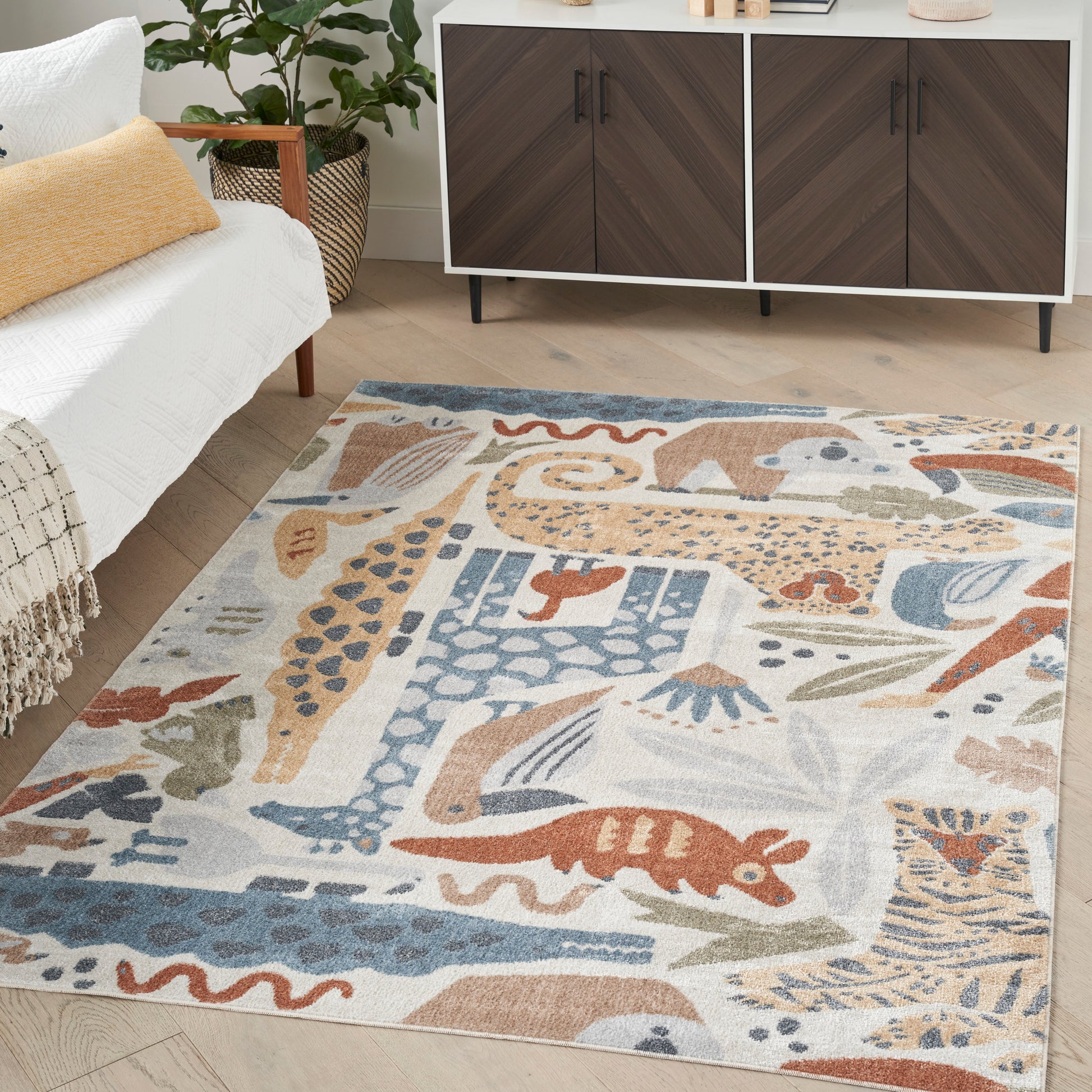 Abstract patterned area rug in blue, tan and coral tones; soft pile for a modern boho living room.