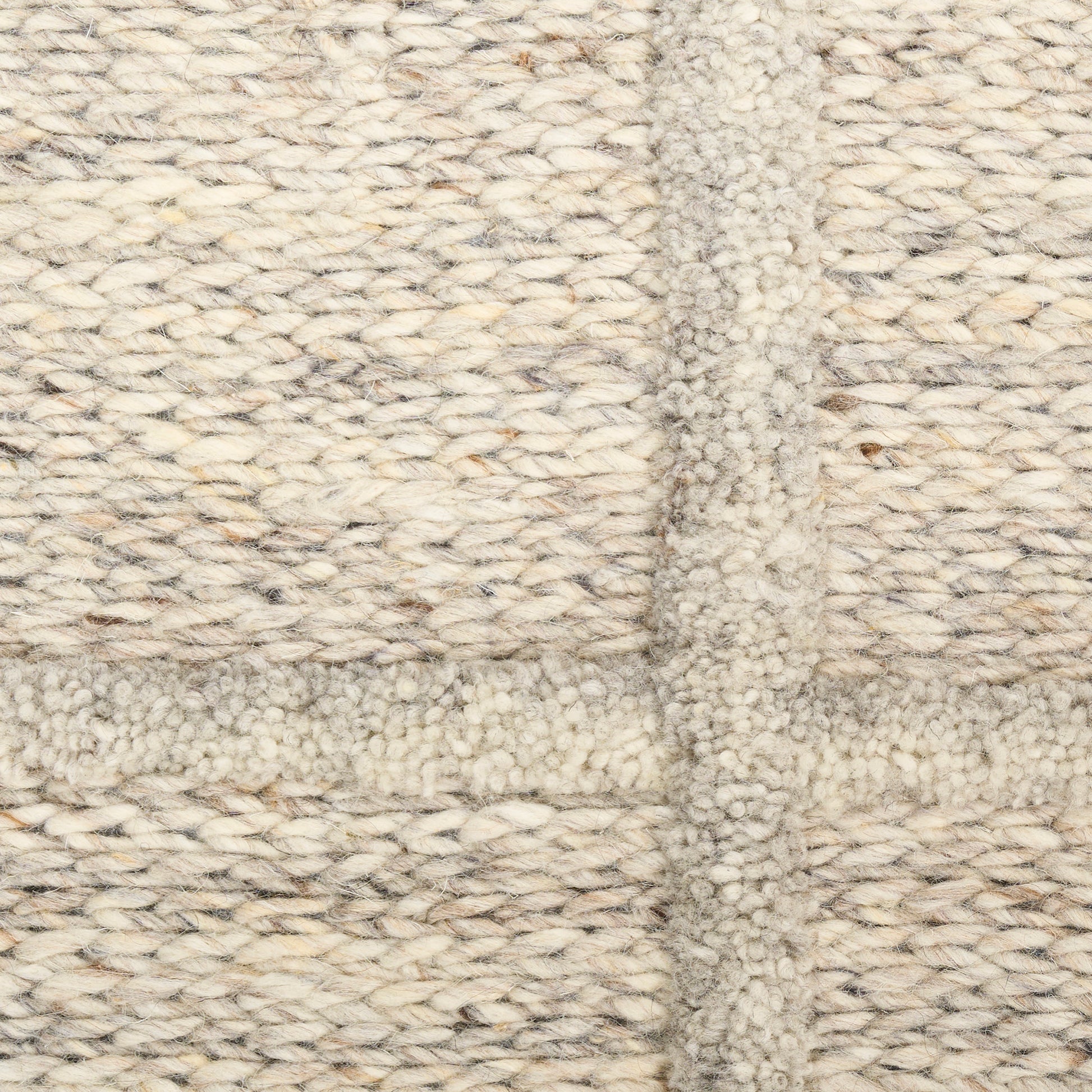 Cream-beige soft chunky-knit textile rug with boucle texture and a woven grid pattern.