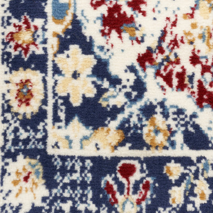 Close-up of a navy blue oriental rug with ivory floral motifs & red and gold accents, plush pile.