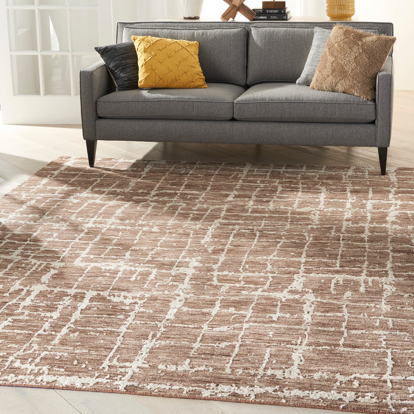Gray rug with a beige-brown lattice pattern; mustard yellow, black, gray, and brown textured accents.