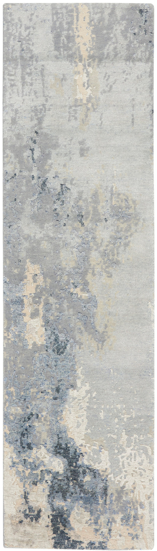 Rectangular runner rug in blue-gray and beige with painterly, washed pattern.