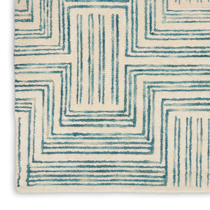 Cream area rug with teal geometric concentric rectangle pattern; contemporary style for living room.